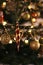 New Year\\\'s golden colored toys and garland hang on a natural Christmas tree. Close-up and soft focus