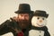 New Year`s holidays. Santa claus man with snowman in black hat.