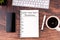 New Year\\\'s Resolutions 2025 text on note pad, pen, smartphone, coffee on wood desk