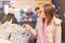 New Year`s shopping. Young girl chooses gifts, souvenirs at the Christmas market