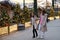 New Year`s shopping. Young girls girlfriends at the market choose gifts, walk on the background of lights and Christmas trees