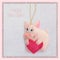 New year. Soft toy made of felt. The cute pig. Piglet is holding a heart. Christmas tree decoration. Symbol of year. 2019.