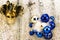 New year theme: Christmas tree white and silver decorations, blue balls, snow, snowflakes, serpentine and golden mask