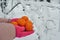 New year time tangerines in the female hands gloves snow winter background