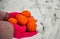 New year time tangerines in the female hands gloves snow winter background