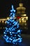 New Year tree on backdrop of a chic building of illuminated railway station