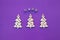 New Year wooden ornaments, top view. Wooden Christmas tree. Violet background. Flat lay style. Inscription wish.