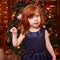 New Year xmas child. Christmas eve holiday. Beautiful little girl. Christmas interior. Blue dress