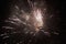 New Years Eve fireworks, several rockets exploding colourfully with many sparks in the beautiful night sky