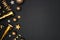 New Years Eve side border of glittery gold stars, streamers, decorations and noisemakers, top view over a black background