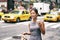 New York Asian business woman walking to work with lunch bag in the morning commuting drinking coffee cup on street with