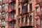 New York bricks buildings facades with fire escape stairs