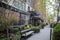 New York City - April 18 2021: Plants, flowers, and oranges growing over an entrance of store. Vintage exterior look of a store