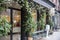 New York City - April 18 2021: Plants, flowers, and oranges growing over an entrance of store. Vintage exterior look of a store