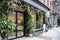 New York City - April 18 2021: Plants, flowers, and oranges growing over an entrance of store. Vintage exterior look of a store