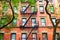 New York City brick apartment building in spring surrounded by green trees.