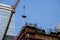 New York City building crane and buildings under construction against blue sky