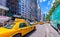 NEW YORK CITY - JUNE 2013: Yellow cabs speed up along city streets. There are more than 10000 taxis in New York