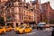 New York City, Madison Avenue - November 1, 2017: Cars and cabs in motion on Madison Avenue against classic architecture and buil