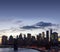 New York City skyline lights at dusk with the Brooklyn Bridge