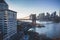 New York City skyline with skyscrapers at sunset. Brooklyn bridge as a connection between Manhattan and Brooklyn