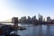 New York City skyline with skyscrapers at sunset. Brooklyn bridge as a connection between Manhattan and Brooklyn