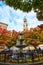 New York City stunning fountain surrounded by fall trees with Christian church steeple behind