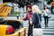 New York city taxi cab driver picking up passanger from the street