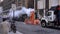 NEW YORK CITY, USA - JANUARY 23, 2021: Steam vapor being vented through an orange and white stack. Road and Truck