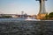 New York, City / USA - JUL 10 2018: Man wearing clown suite riding jet ski water bike in East River under Manhattan Bridge