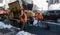New York City, USA - March 17, 2017 - Road construction crew and equipment laying a new asphalt surface
