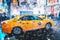 New York City, USA - March 18, 2017: People in yellow cab shot famous led advertising panels in Times Square during snow, one of