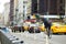 NEW YORK - MARCH 16, 2015: Cyclist and taxi cabs rushing on busy streets of downtown Manhattan.