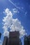 New York, New York: Under a bright blue sky with dramatic clouds, construction of a modern 42-story hi-rise building