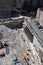 New York, New York: Workers use a cement mixer with a long arm to construct a retaining wall