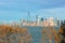 NEW YORK, NY - 04 NOV 2019: The Manhattan Skyline seen from Ellis Island with beautiful fall trees in the foreground