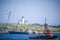 New York, NY: Bayonne Golf Club lighthouse and golf course in the New York Bay with various shipping vessels on a