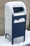 New York, NY, USA: Blue United States Postal Service mailbox covered in snow