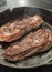 New York Strip Steaks in iron skillet