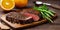 New York Striploin on wooden board. Fresh juicy delicious beef steak on wooden board. Piece of roast beef with rosemary.