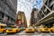 The New York Times building and characteristic Yellow Taxi Cab,on December 01th, 2013 in Manhattan, New York City. USA.