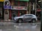 New York, United States, USA March 23, 2020: rainy new york day, man with mask closing shop during coronavirus outbreak