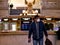 New York, United States, USA March 26, 2020: man with mask in front of empty grand central station information during