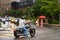 NEW YORK, USA - 11 JULY 2019: motorcyclist and cars wait at traffic lights while pedestrians cross the road in rainy day