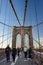 NEW YORK, USA - 21 OCTOBER 2018: Pedestrians walk over the Brooklyn Bridge at sunset. Brooklyn Bridge from New York City to