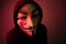 New York, USA - 22 april 2021: man wearing vendetta mask with hoodie on black background. This mask is symbol for Anonymous