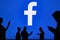 NEW YORK, USA, 25. MAY 2020: Facebook online social media and social networking Group of business people chat on mobile phone and