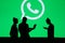 NEW YORK, USA, 25. MAY 2020: WhatsApp cross-platform messaging and Voice over service Group of business people chat on mobile