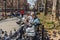NEW YORK, USA - APRIL 14, 2018: An elderly man feeding pigeons in a park near with the West Village in New York.