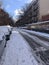 New York, USA - December 12: East Village street in Manhattan covered with pile of snow. Empty winter road with melting snow